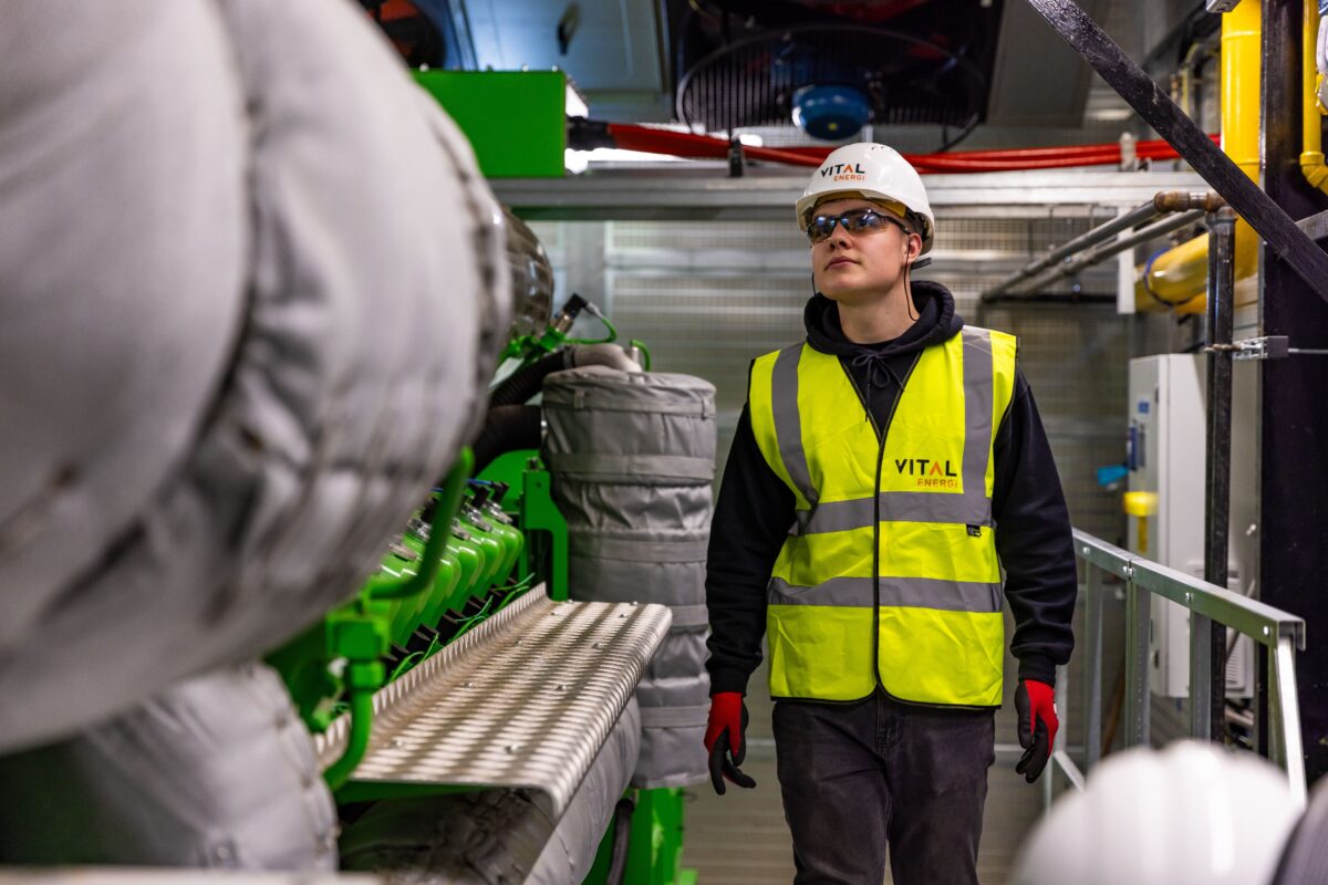 Safety officer reviewing site documentation with a worker in hi-vis on an industrial worksite